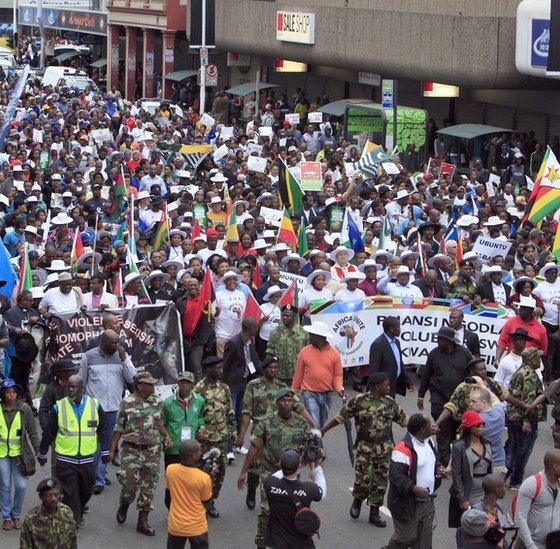 South African anti-migrant protesters march after Ramaphosa warns vigilantes
